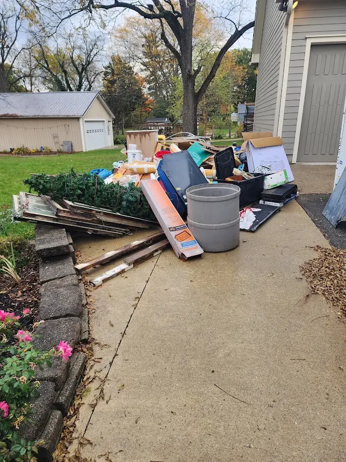 Dumpster being loaded with debris for Estate Cleanout Dumpster Rental in Forks
